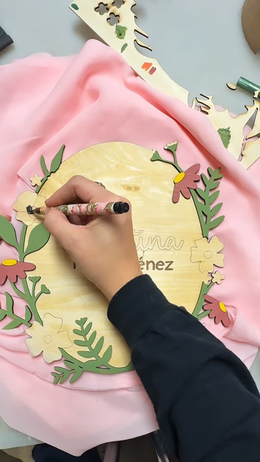 Custom wood name sign with hand-painted floral wreath